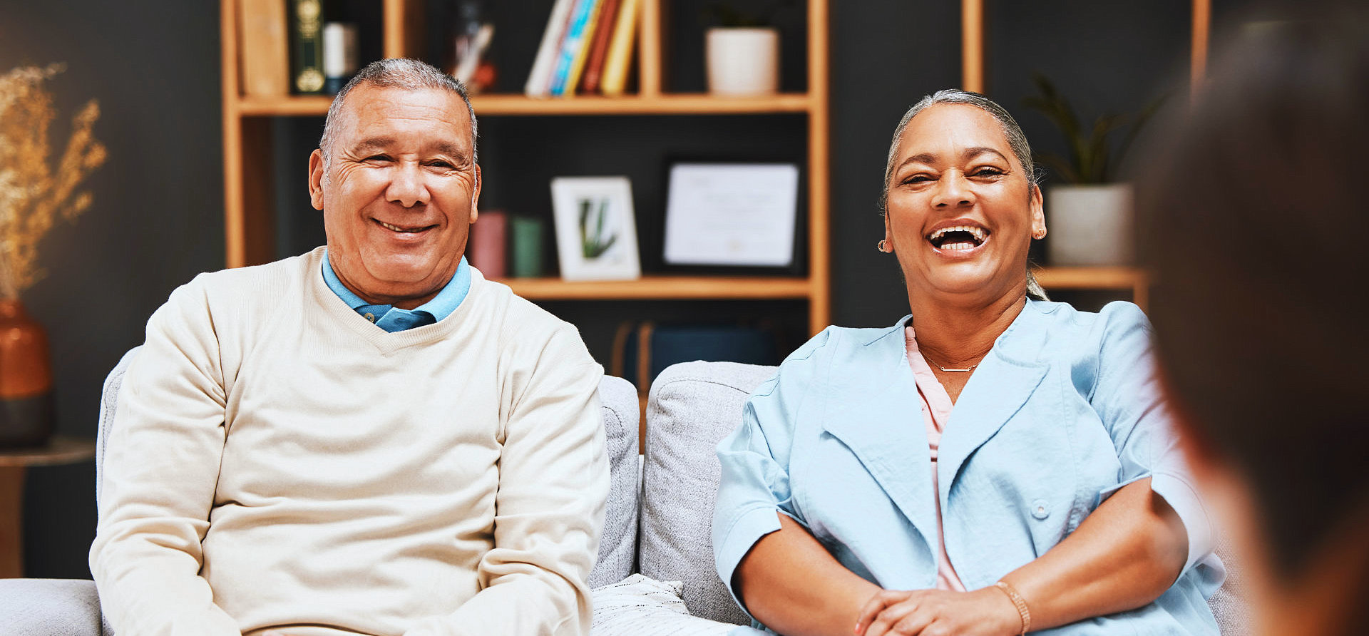 senior man and woman setting on sofa