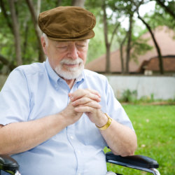 Elderly man praying.