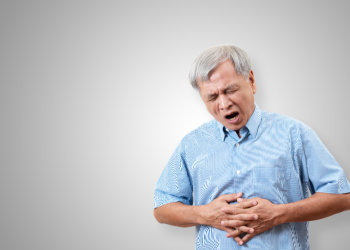 Older asian man is having stomach ache pain.