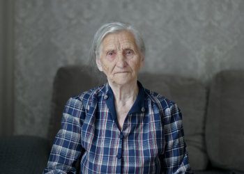 A cute Senior woman looks at the camera.