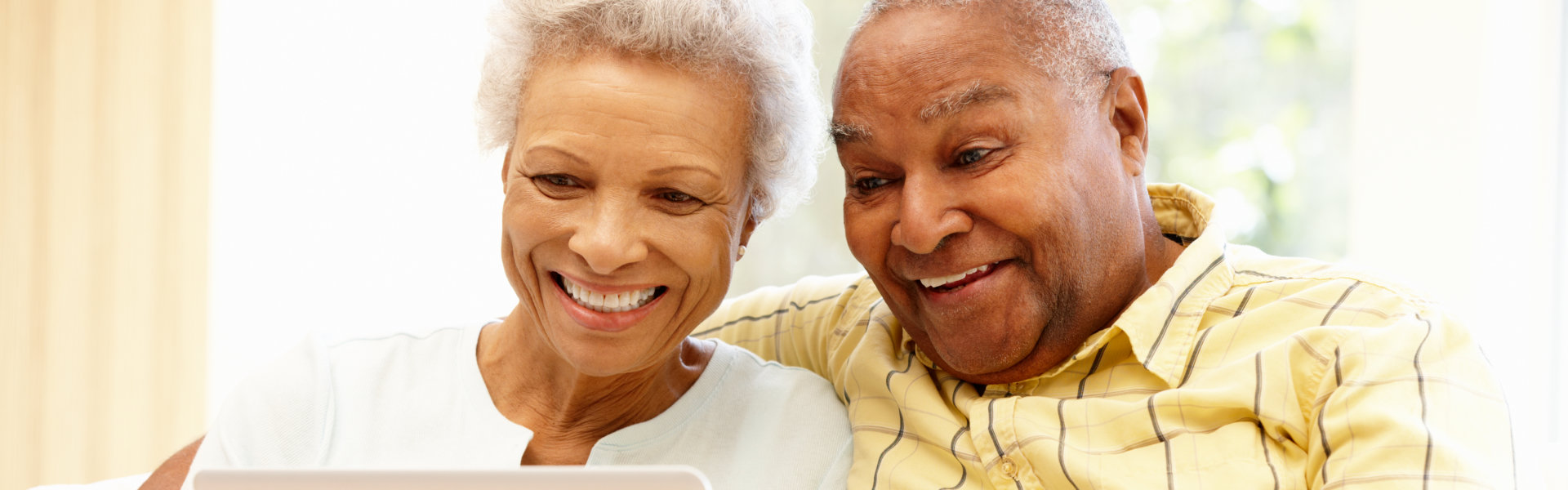 Senior African American couple using laptop.